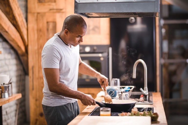 Man cooking eggs for breakfast to support his weight loss goals
