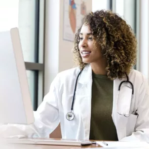 Healthy doctor on the computer; concept for how doctors boost their immunity to stay healthy