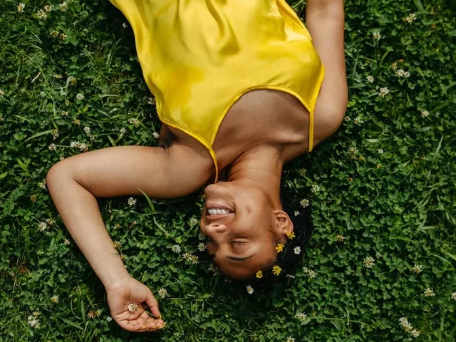 best supplements for spring woman smiling in grass