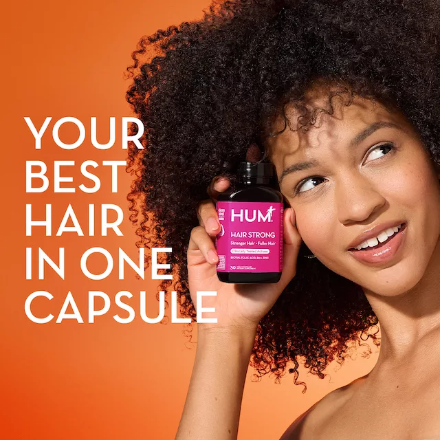 Fo-ti for hair health. Woman holding supplement.